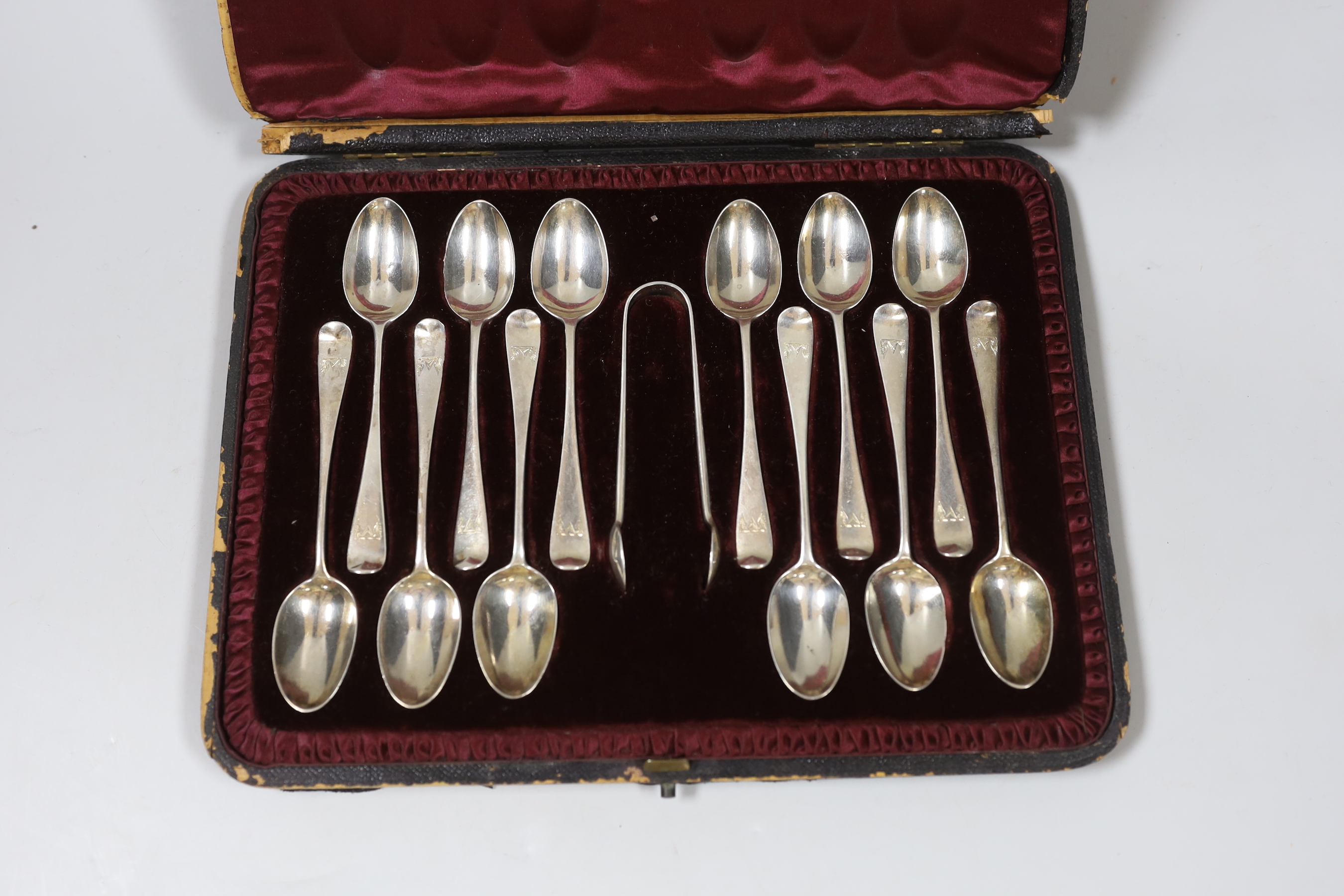 A cased set of twelve late Victorian silver Old English pattern teaspoons and tongs, London, 1892.